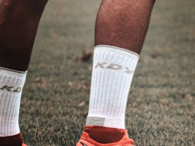 Close-up of athletic shoes on a training mat, symbolizing stability and balance.
